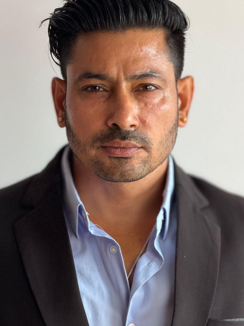 Representative portrait — Close-up of a confident businessman in a suit, showcasing professionalism and determination.