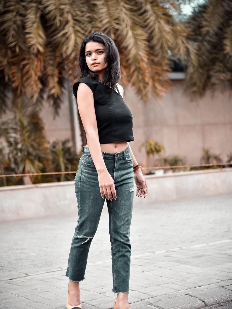 Representative portrait — Fashionable young woman in casual wear posing confidently outdoors, showcasing modern style.